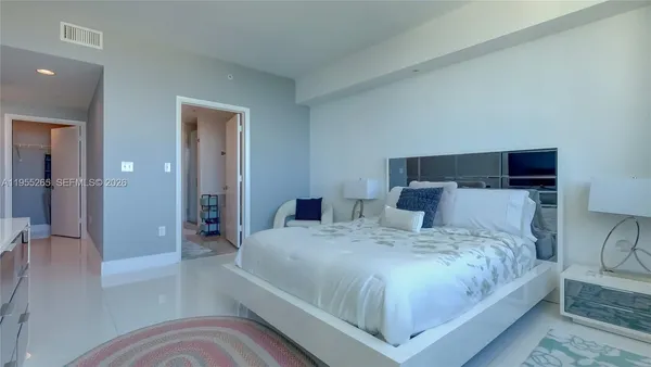 a bedroom with a large bed and a view of bathroom