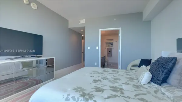 a bedroom with a bed and a dresser