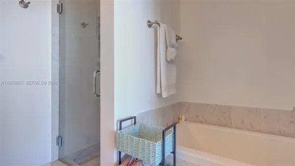 a bathroom with a bathtub and shower