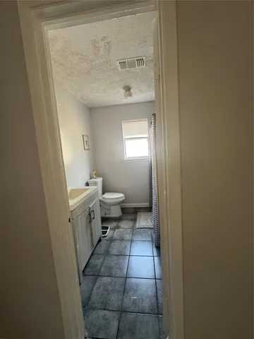 a bedroom with a bed and a chair