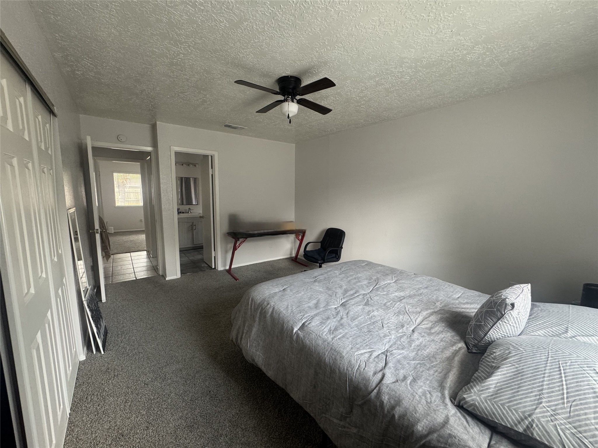 2323 Spring Dusk Drive Spring, TX 77373 - Photo 16 of 19 a bedroom with a bed and a chandelier