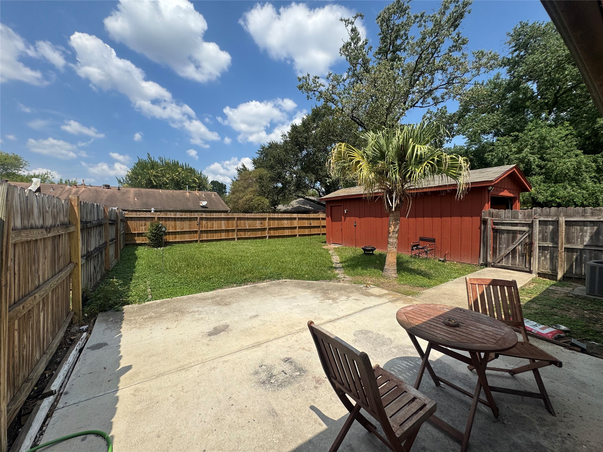 2323 Spring Dusk Drive Spring, TX 77373 - Photo 2 of 19 a view of a backyard with table and chairs with wooden fence