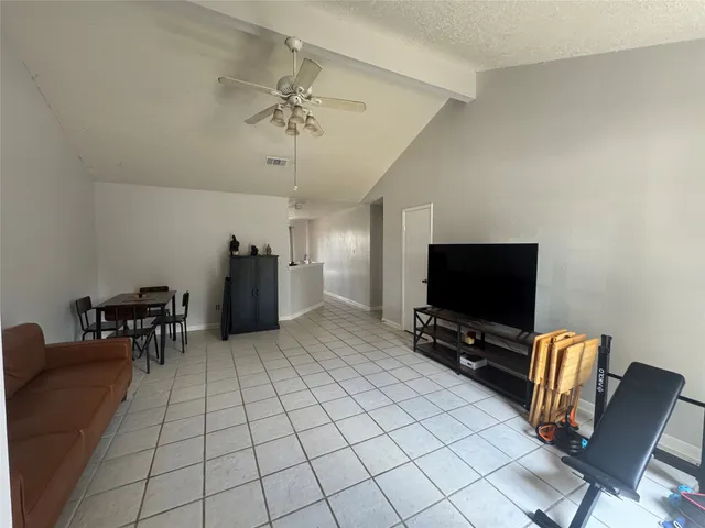 a view of a livingroom with furniture and a flat screen tv