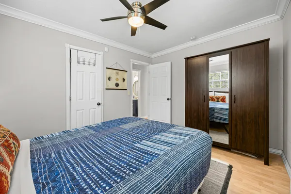 a bedroom with a bed and a mirror