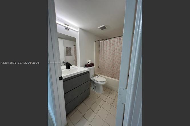 3700 North 56th Avenue, Unit 1012 Hollywood, FL 33021 - Photo 11 of 11 a bathroom with a sink a toilet a mirror and shower