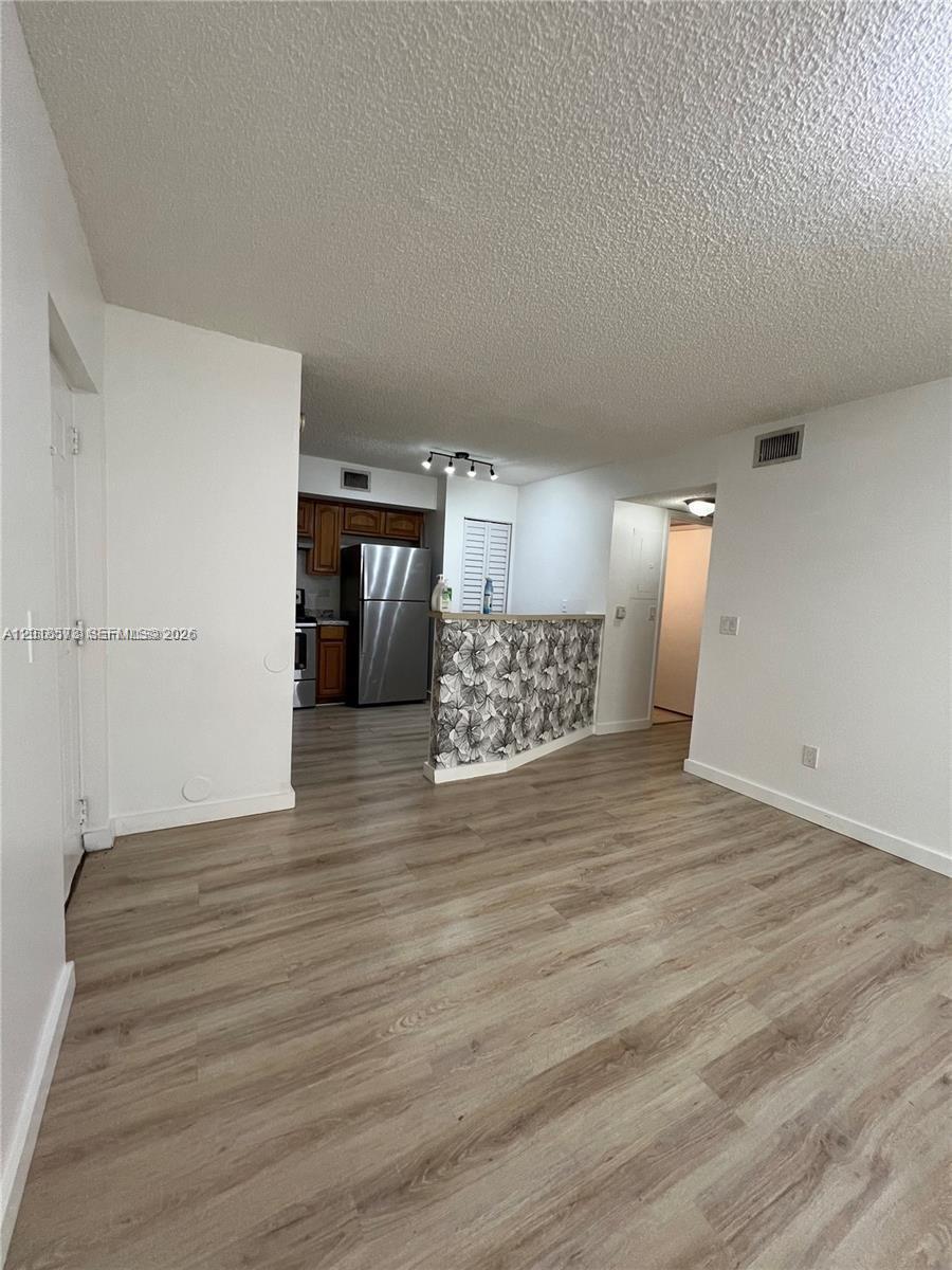 3700 North 56th Avenue, Unit 1012 Hollywood, FL 33021 - Photo 3 of 11 a view of a hallway with wooden floor