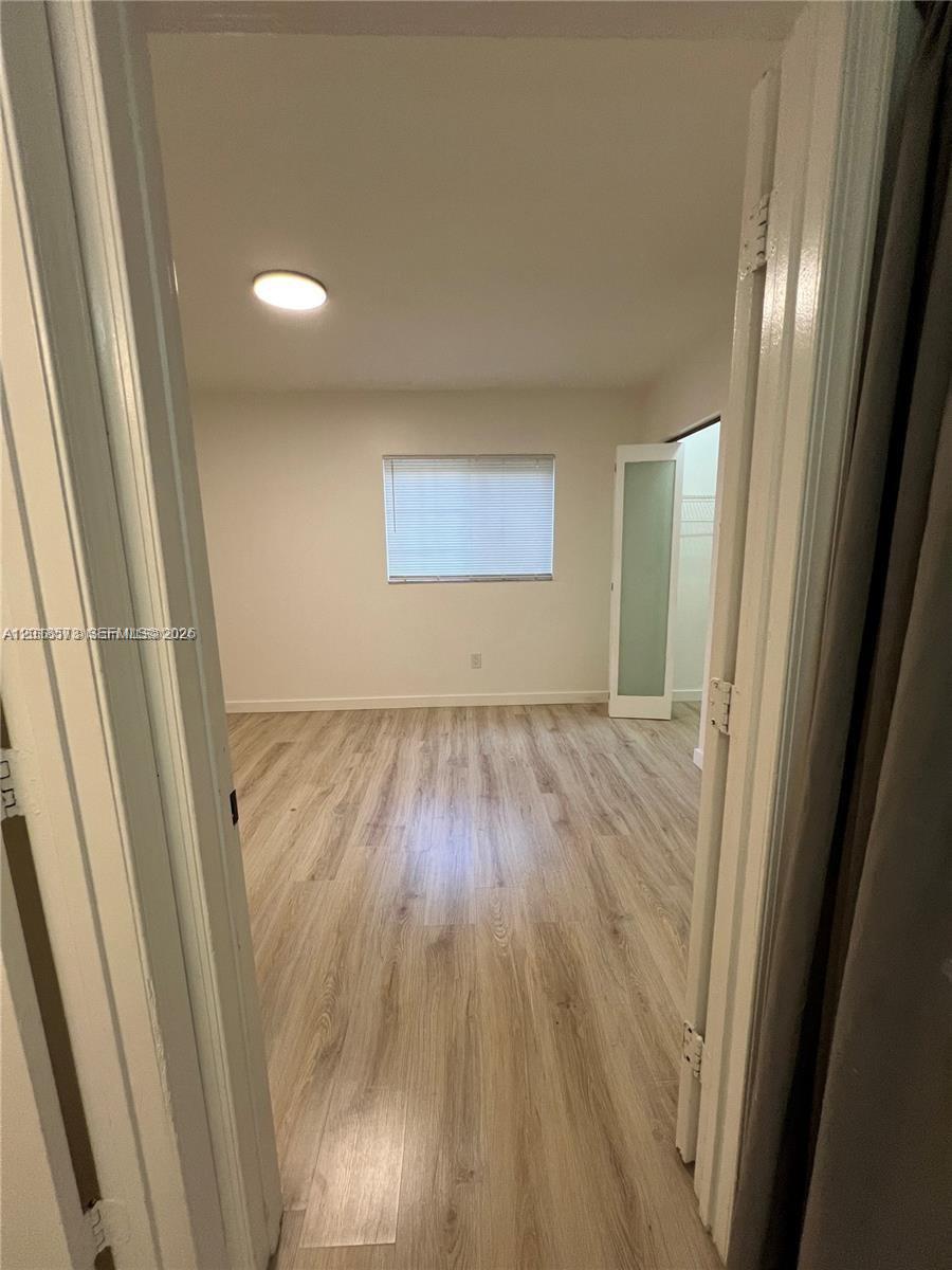 3700 North 56th Avenue, Unit 1012 Hollywood, FL 33021 - Photo 4 of 11 a view of hallway with wooden floor