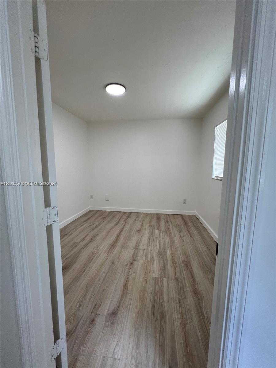 3700 North 56th Avenue, Unit 1012 Hollywood, FL 33021 - Photo 5 of 11 wooden floor in an empty room