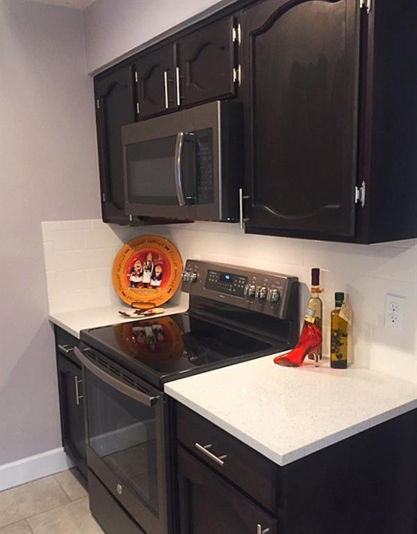 3305 Spaniel Drive Austin, TX 78759 - Photo 17 of 20 Culinary delights await in this sleek kitchen featuring contemporary cabinetry and essential appliances.