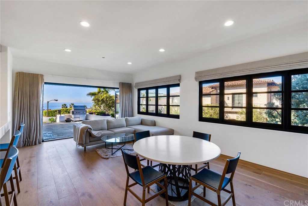 4 Emerald Bay Laguna Beach, CA 92651 - Photo 22 of 75 a living room with furniture and a potted plant
