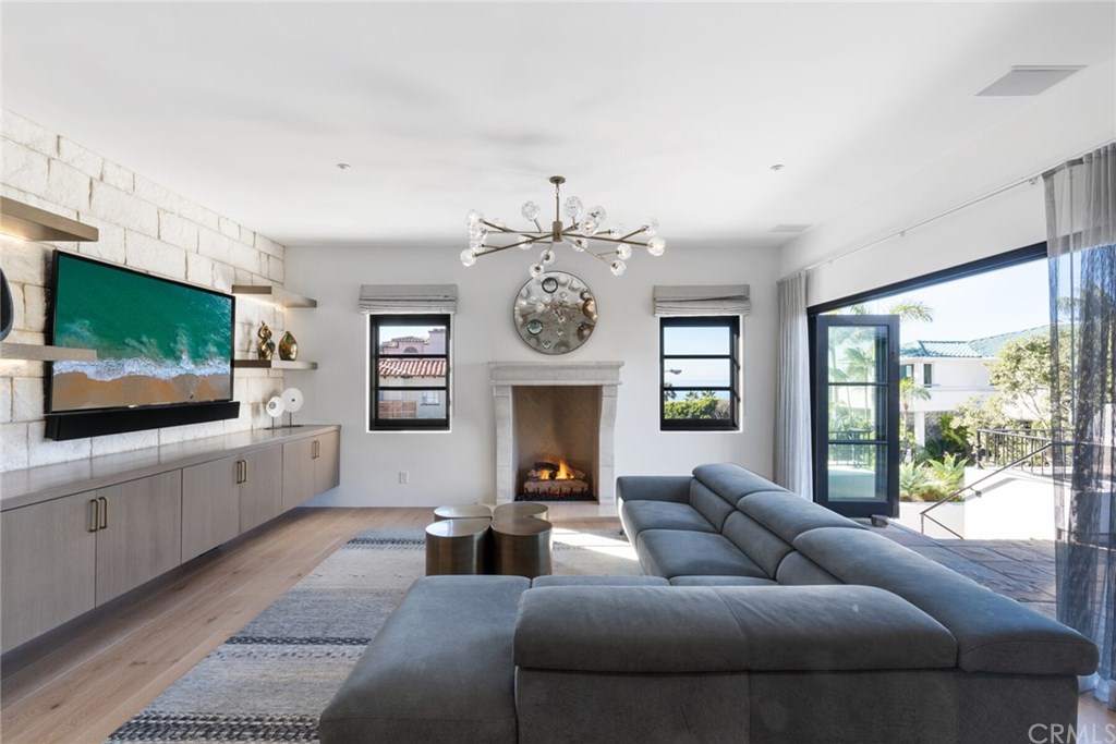 4 Emerald Bay Laguna Beach, CA 92651 - Photo 25 of 75 a living room with fireplace furniture and a flat screen tv