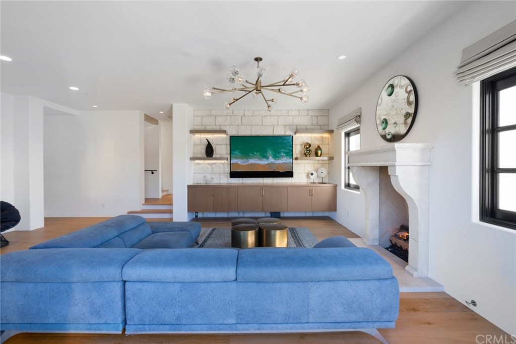 4 Emerald Bay Laguna Beach, CA 92651 - Photo 26 of 75 a living room with furniture a clock and a fireplace