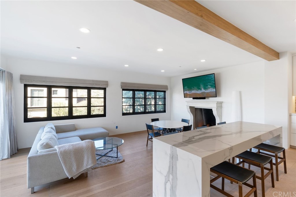 4 Emerald Bay Laguna Beach, CA 92651 - Photo 32 of 75 a living room with furniture a table and a fireplace