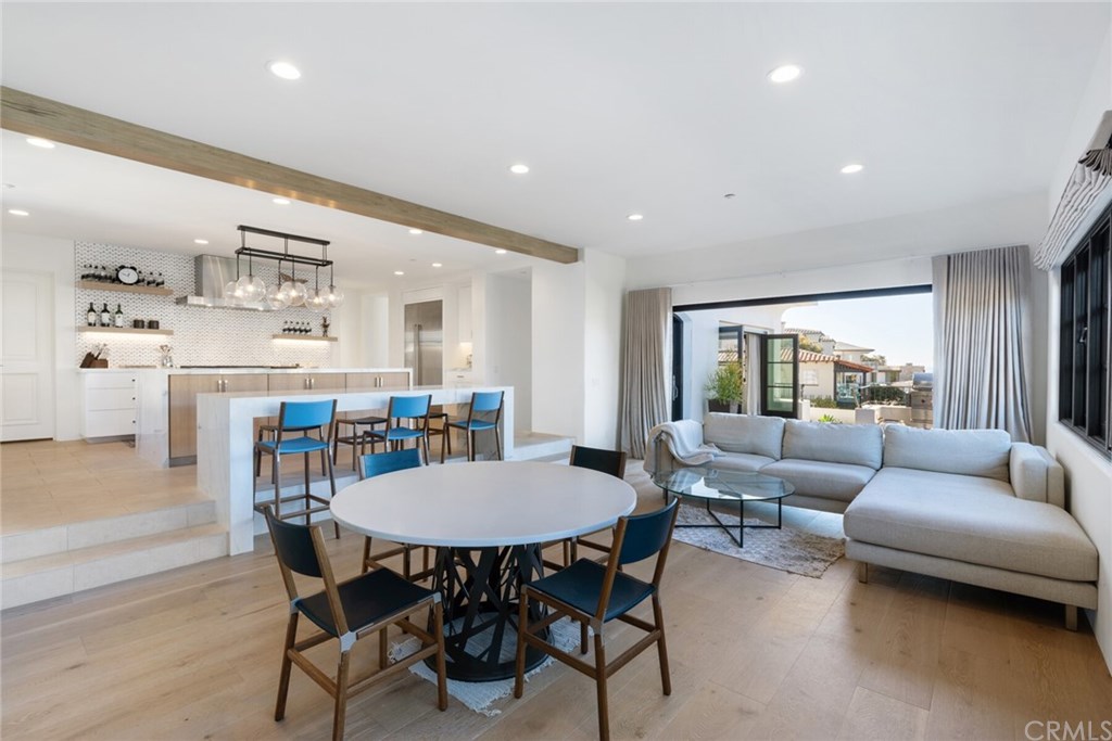 4 Emerald Bay Laguna Beach, CA 92651 - Photo 34 of 75 a living room with furniture and a dining table with wooden floor