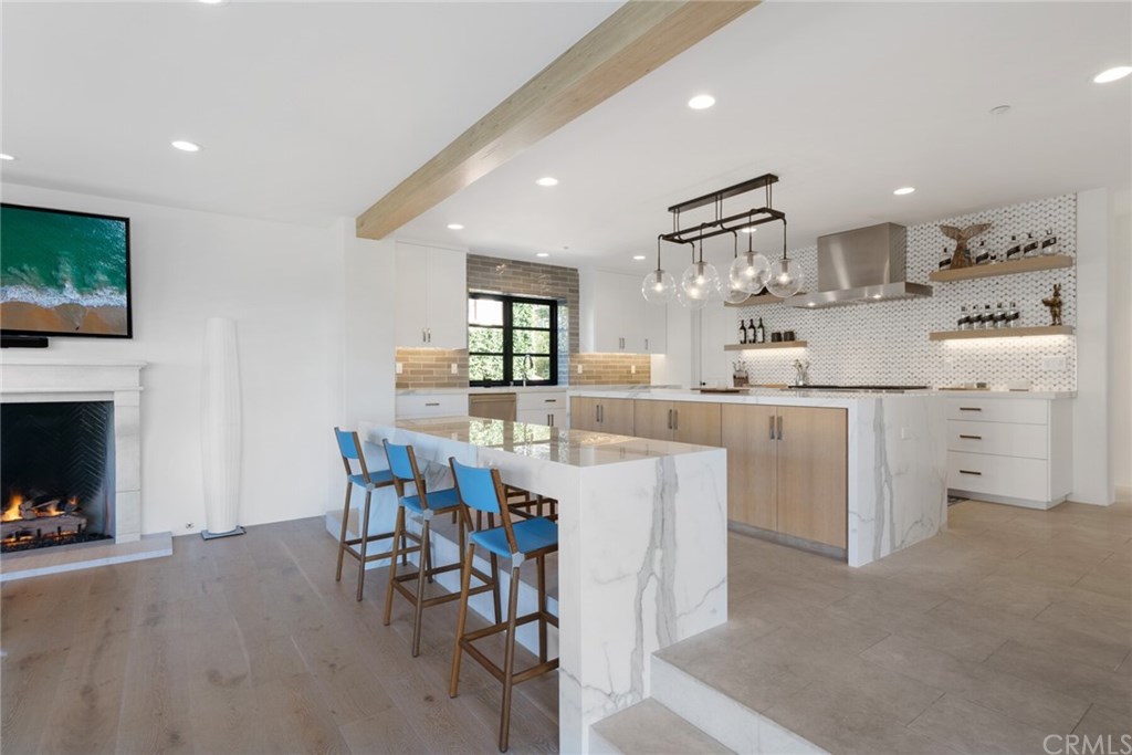 4 Emerald Bay Laguna Beach, CA 92651 - Photo 36 of 75 a kitchen with white cabinets and chairs