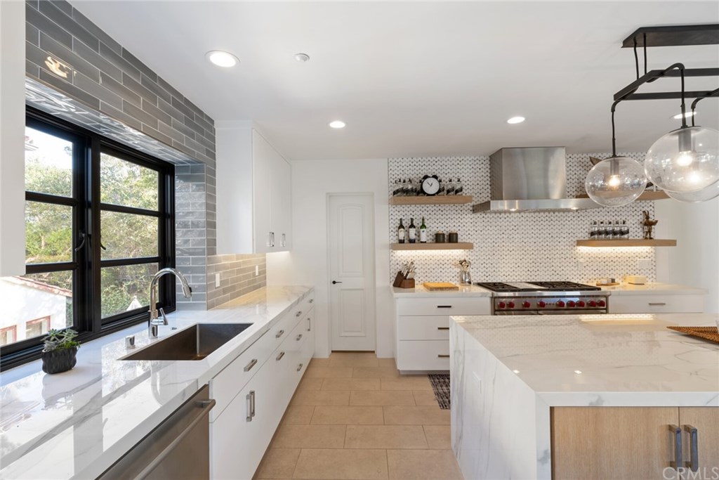 4 Emerald Bay Laguna Beach, CA 92651 - Photo 38 of 75 a kitchen with stainless steel appliances a sink stove and cabinets