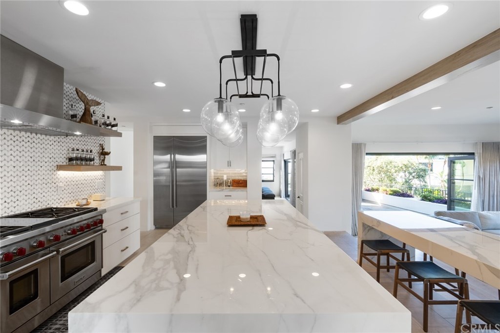 4 Emerald Bay Laguna Beach, CA 92651 - Photo 41 of 75 a kitchen with stainless steel appliances a dining table chairs stove and refrigerator