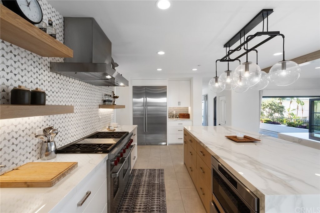 4 Emerald Bay Laguna Beach, CA 92651 - Photo 42 of 75 a kitchen with stainless steel appliances a sink stove and refrigerator