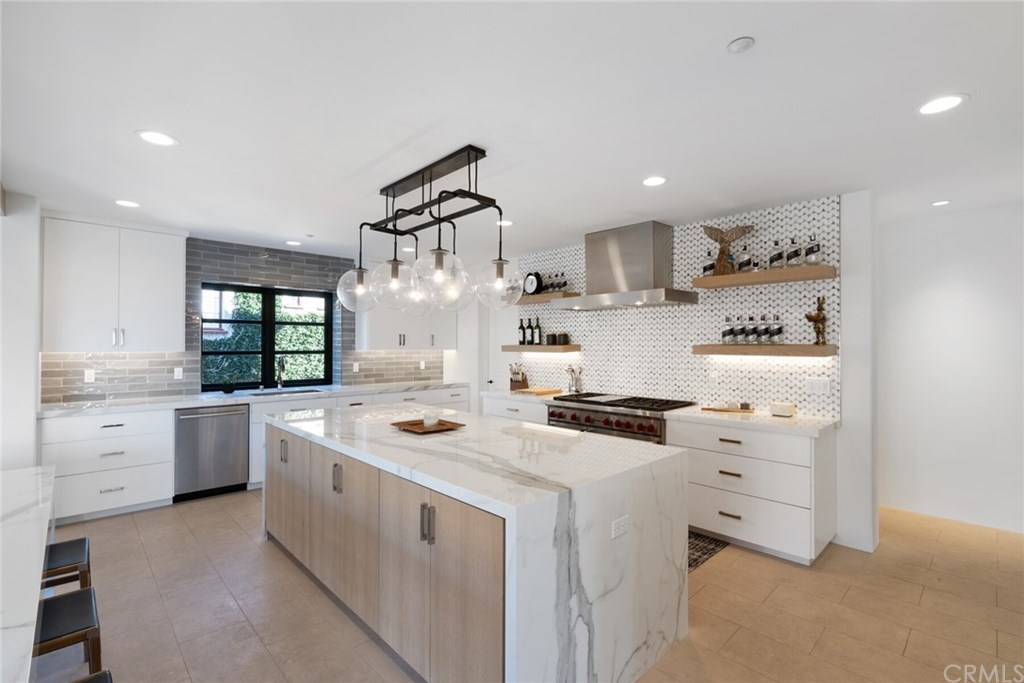 4 Emerald Bay Laguna Beach, CA 92651 - Photo 49 of 75 a kitchen that has a lot of cabinets in it and wooden floors
