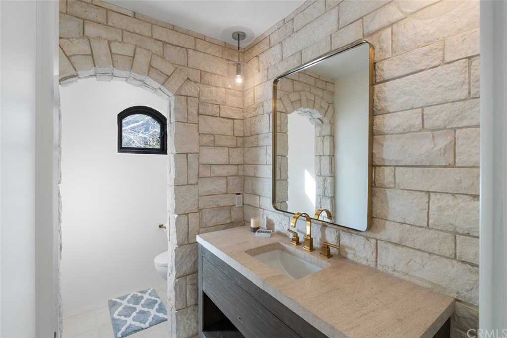 4 Emerald Bay Laguna Beach, CA 92651 - Photo 52 of 75 a bathroom with a sink and a mirror
