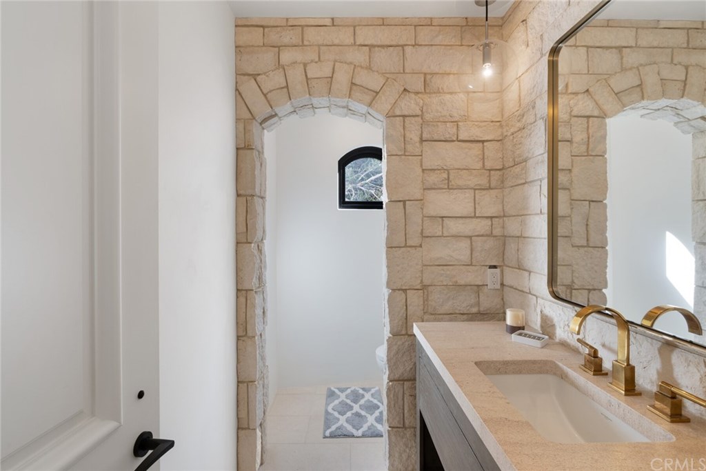 4 Emerald Bay Laguna Beach, CA 92651 - Photo 53 of 75 a bathroom with a sink and mirror