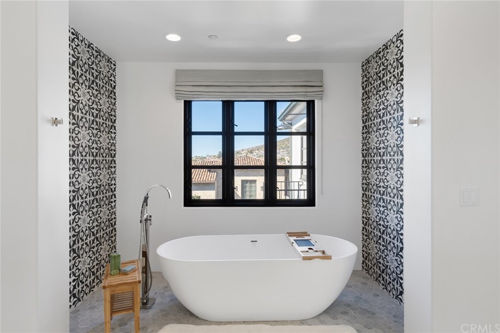 4 Emerald Bay Laguna Beach, CA 92651 - Photo 66 of 75 a bathroom with a bathtub a window and a shower