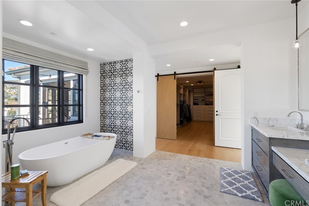4 Emerald Bay Laguna Beach, CA 92651 - Photo 71 of 75 a spacious bathroom with a tub sink and mirror