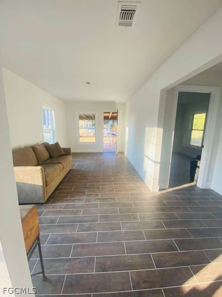 5136 McDonald Road Zellwood, FL 32798 - Photo 12 of 17 a living room with furniture a window and a mirror