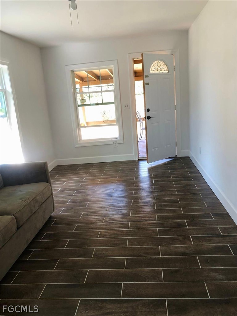 5136 McDonald Road Zellwood, FL 32798 - Photo 15 of 17 a view of empty room with wooden floor and window
