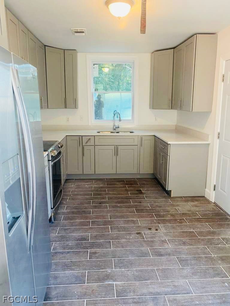 5136 McDonald Road Zellwood, FL 32798 - Photo 8 of 17 a kitchen with a refrigerator and window