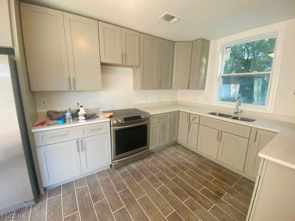 5136 McDonald Road Zellwood, FL 32798 - Photo 9 of 17 a kitchen with a sink cabinets and window