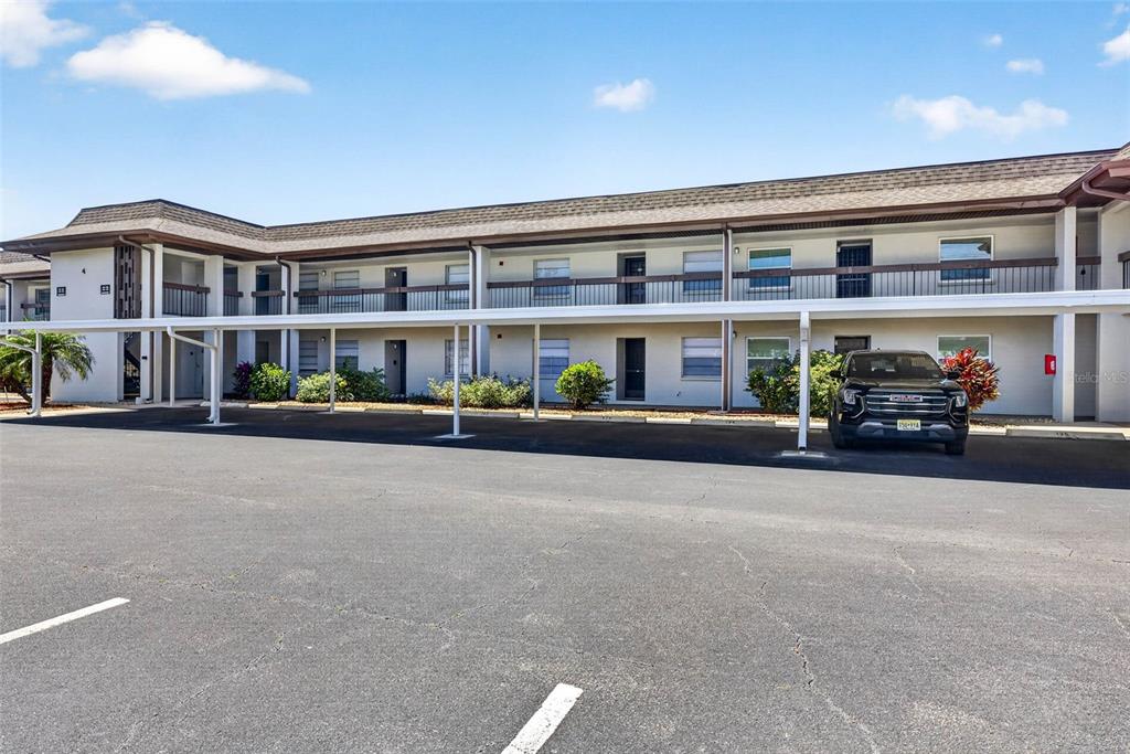 5197 Silent Loop, Unit 124 New Port Richey, FL 34652 - Photo 2 of 55 a view of building with cars parked