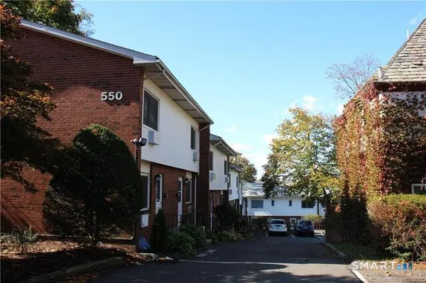 a front view of a house with trees