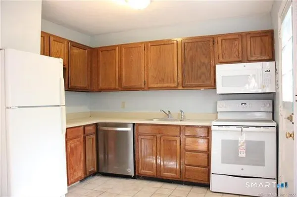 a kitchen with a sink a stove and cabinets