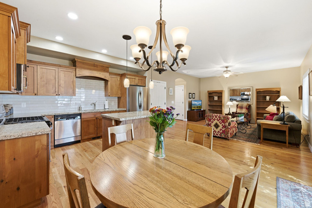 7235 Viansa Court Midvale, UT 84047 - Photo 8 of 43 Dining space with arched walkways, light wood finished floors, suspended lighting, and a ceiling fan