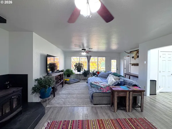 a view of living room filled with furniture and book shelf