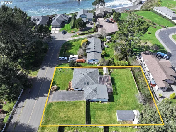 an aerial view of a house with a yard and a sitting area