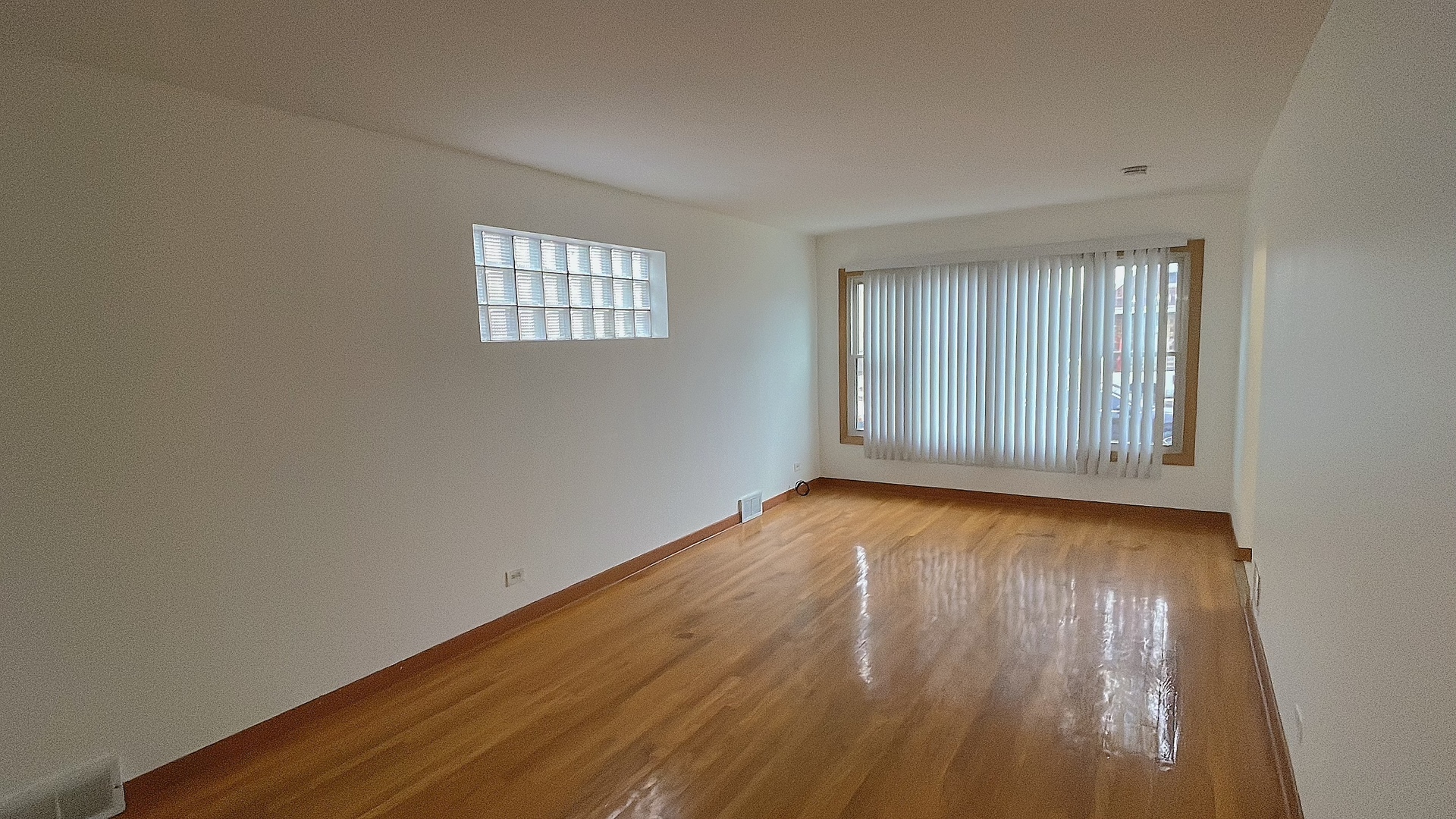 Undisclosed Address Chicago, IL 60629 - Photo 4 of 18 an empty room with wooden floor and windows