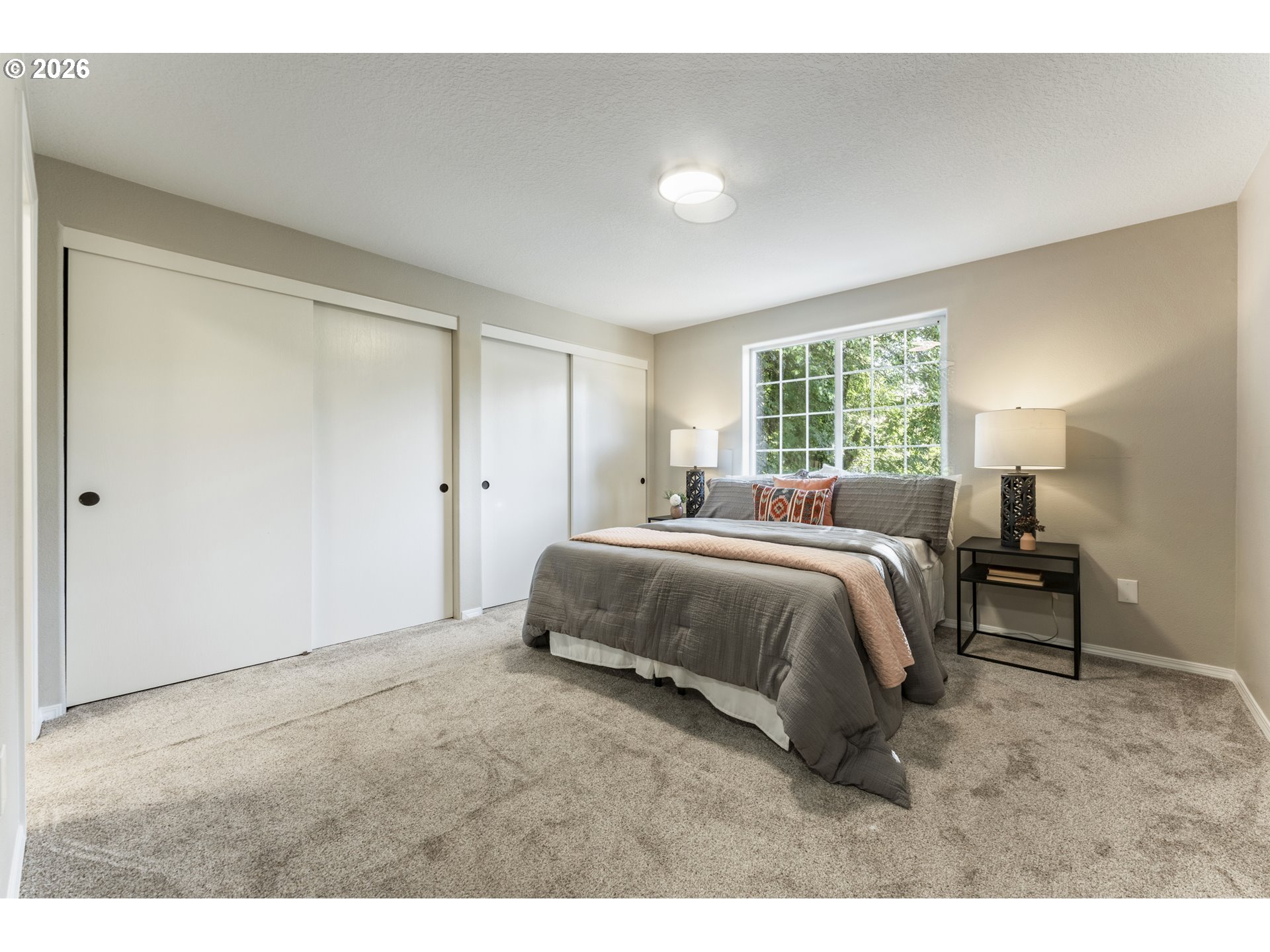 4024 Southeast 154th Place Portland, OR 97236 - Photo 11 of 43 a spacious bedroom with a bed and a table