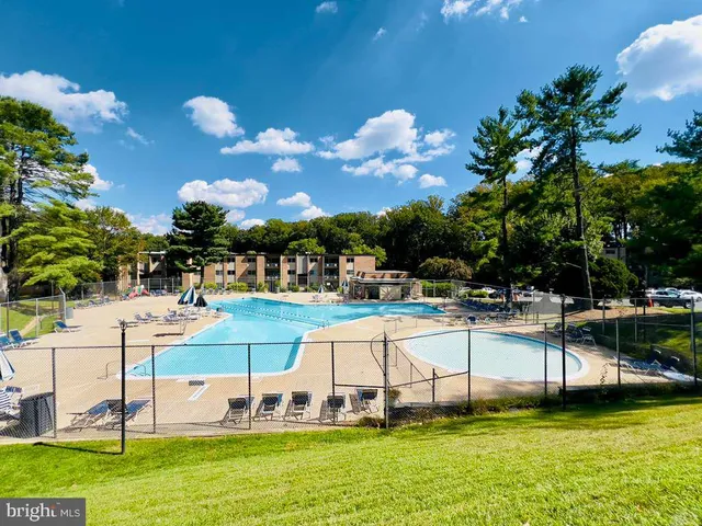 a view of a swimming pool with outdoor seating