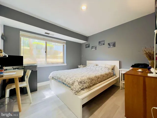 a bedroom with a bed and a table in it