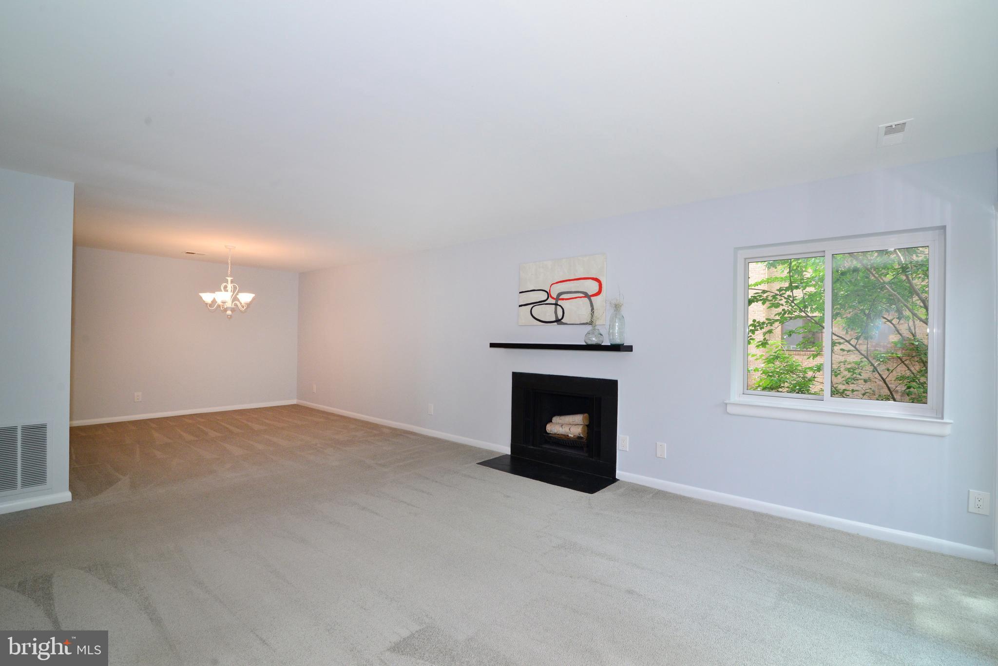11128 Harbor Court Reston, VA 20191 - Photo 10 of 44 The living room opens to the dining room.