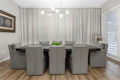 a dinning room with furniture and floor to ceiling window