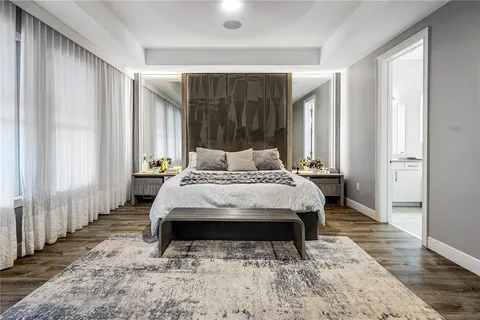 a view of an empty room with wooden floor and stairs