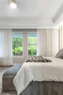 a living room with furniture a dining table and chairs with wooden floor