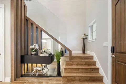 a view of entryway and hall with wooden floor