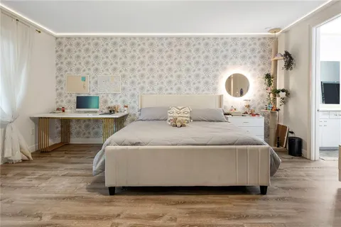 a view of a patio with table and chairs with wooden fence and plants