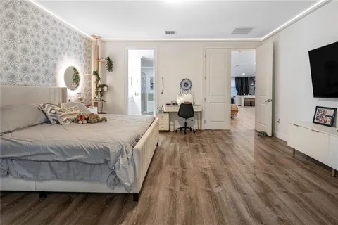 a living room with patio furniture and a potted plant