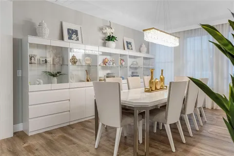 a large white kitchen with stainless steel appliances