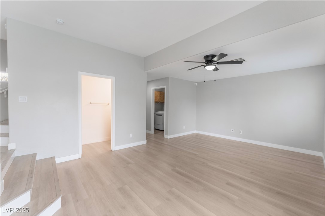 3695 Funston Way Las Vegas, NV 89129 - Photo 16 of 43 Unfurnished living room with light wood-style flooring, ceiling fan, and washer / clothes dryer